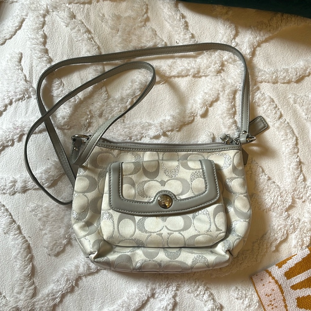 Silver and white Coach crossbody